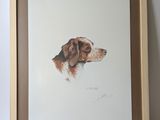 painting of a brown and white dog in a wooden frame on a wall