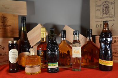 many bottles of alcohol sitting on a table next to boxes