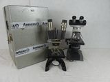 two microscopes and a box on a table
