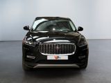 the front view of a black jaguar suv parked in a showroom