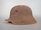 an old helmet with holes on the side of it on a table
