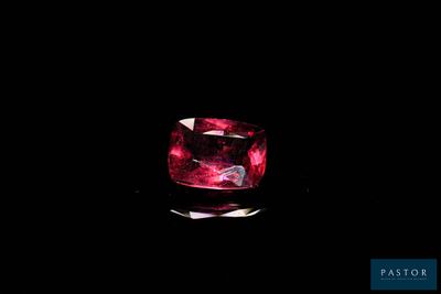 a close up of a pink diamond on a black background