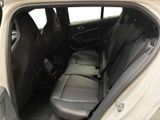 the back seat of a car with the door open and the passenger seat down