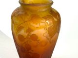 a glass vase with a flower design on it on a table