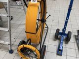 a yellow hose on a cart in a warehouse