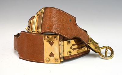 brown leather belt with brass buckle on white background