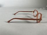 pair of glasses on a white surface with a white background