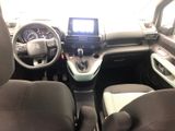 the interior of a small car with a steering wheel and dashboard