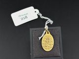 a gold coin with a tag on it sitting in a black box