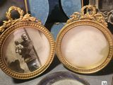 two framed pictures of a man and a woman on a table