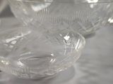 a lot of glass bowls and cups on a table