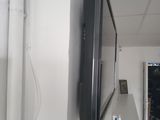 a flat screen tv mounted on a wall in a room