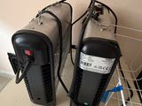 two air purifiers sitting on a shelf next to each other