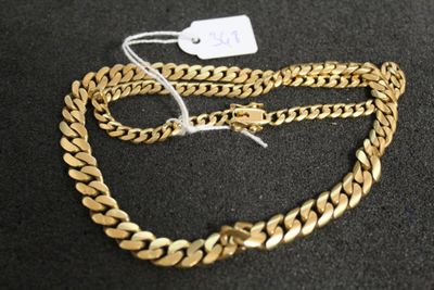 a close up of a gold chain with a tag on it