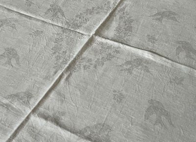 a close up of a bed with a white comforter on it