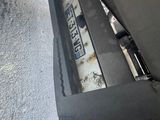 a close up of a car ' s bumper with a number plate on it
