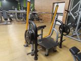 a gym room with a row of stationary exercise machines