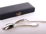 two forks and spoons sitting next to a black box