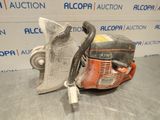 a close up of a chainsaw on a table in front of a sign