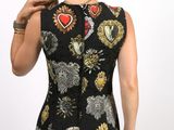 the back of a woman in a black dress with a red heart on it