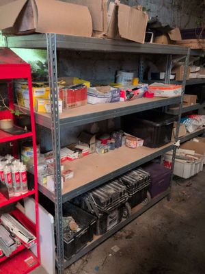 a red shelf with many items on it in a room