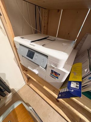 a printer that is sitting on top of a cabinet
