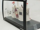 a glass display case with a castle in it