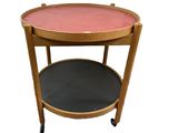 an image of a wooden table with a pink top on wheels