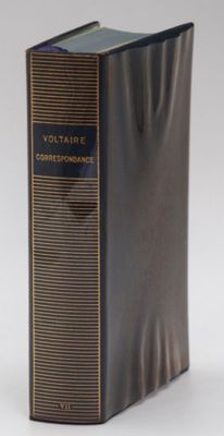 an old book is sitting on a table with a white background