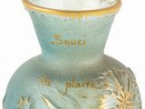 a blue vase with gold decoration on it on a white surface