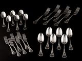 a lot of silver spoons and forks on a black background
