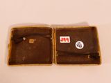 a small brown case with a sticker on it