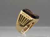 an image of a gold ring with a brown stone in it