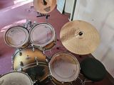 a drum set up on the floor in a room