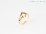 a close up of a gold ring on a white surface
