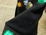 a black jacket with green buttons on it