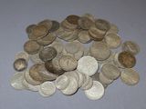 a pile of coins sitting on a table next to a pair of scissors