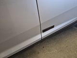 a picture of a white car with a sticker on the door