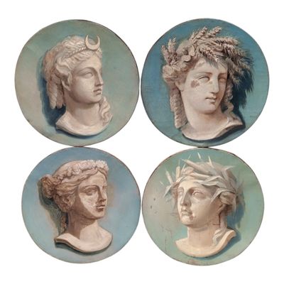 four plates with heads of men and women on them in blue and white