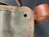 a close up of a canvas bag with a leather handle
