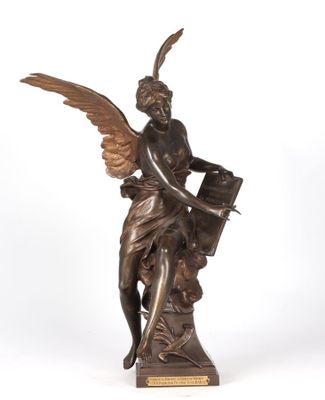 an antique bronze statue of an angel holding a book