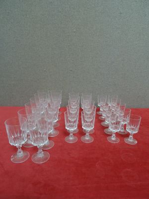a lot of empty wine glasses on a red table
