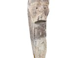 an image of a sculpture of a man ' s head on a wooden base