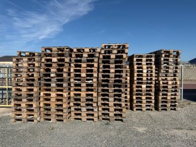 many wooden pallets stacked on top of each other