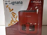 the box of a red juicer is sitting on a table
