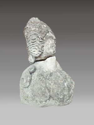 a close up of a statue of a man on a rock