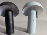 two black and white lamps sitting next to each other on a table