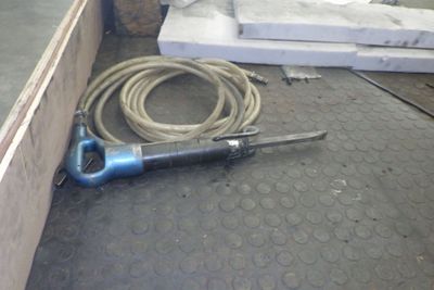 a picture of a hose laying on the floor next to a piece of wood