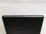 the back of a black laptop computer sitting on top of a table