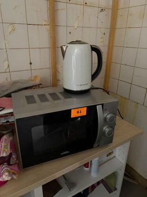 a microwave sitting on top of a shelf in a kitchen